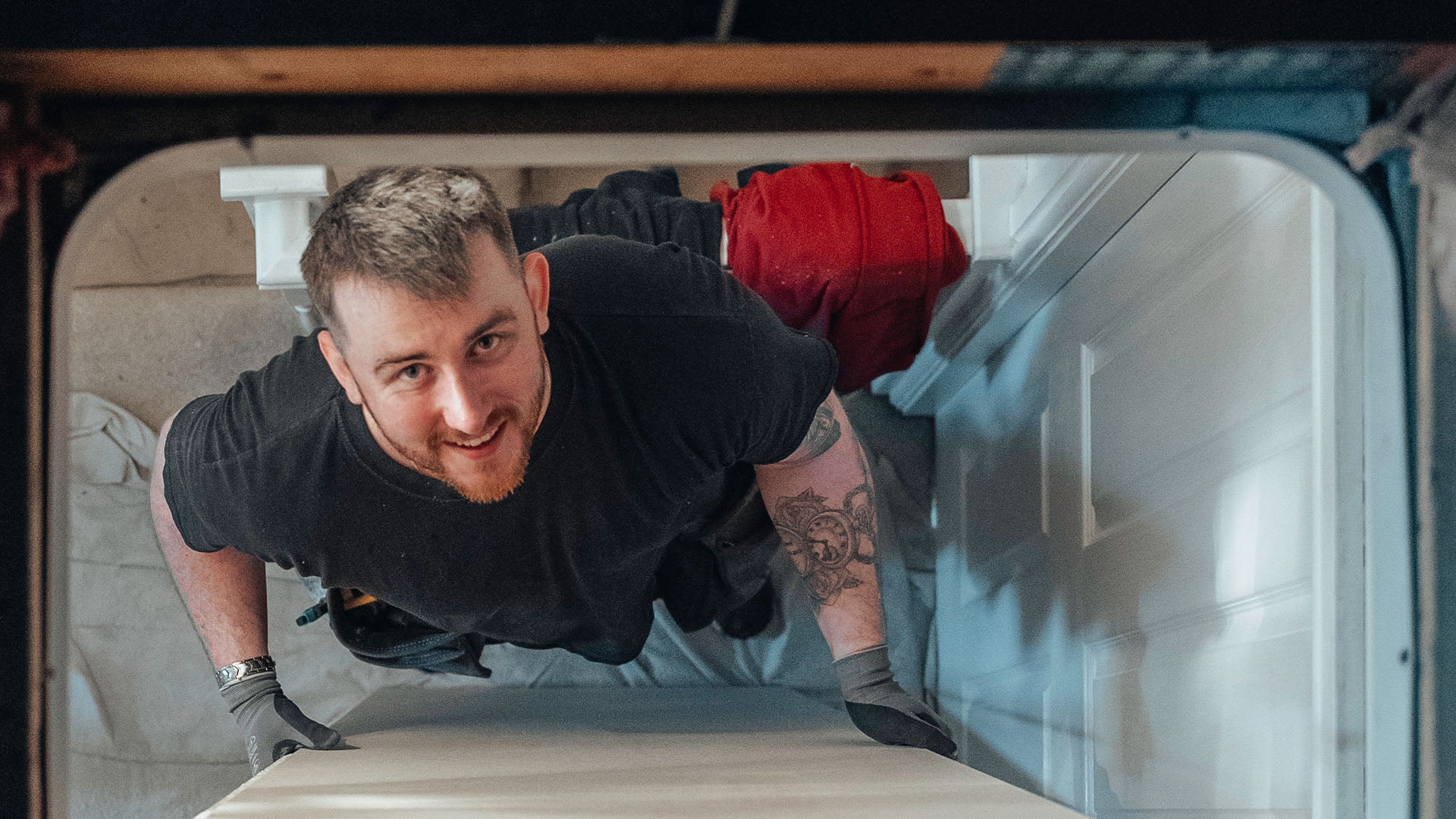 Loft installer looking up through loft hatch — Loft-Trac