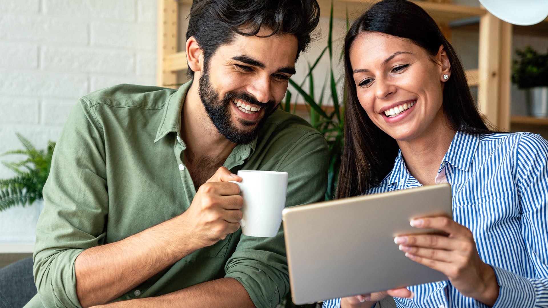 Couple using tablet to accept loft installation — Loft-Trac