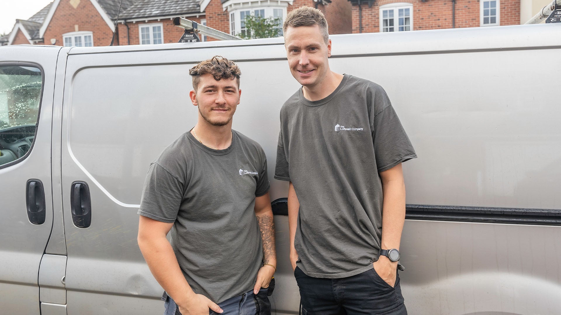 Two loft fitters smiling at camera — Loft-Trac