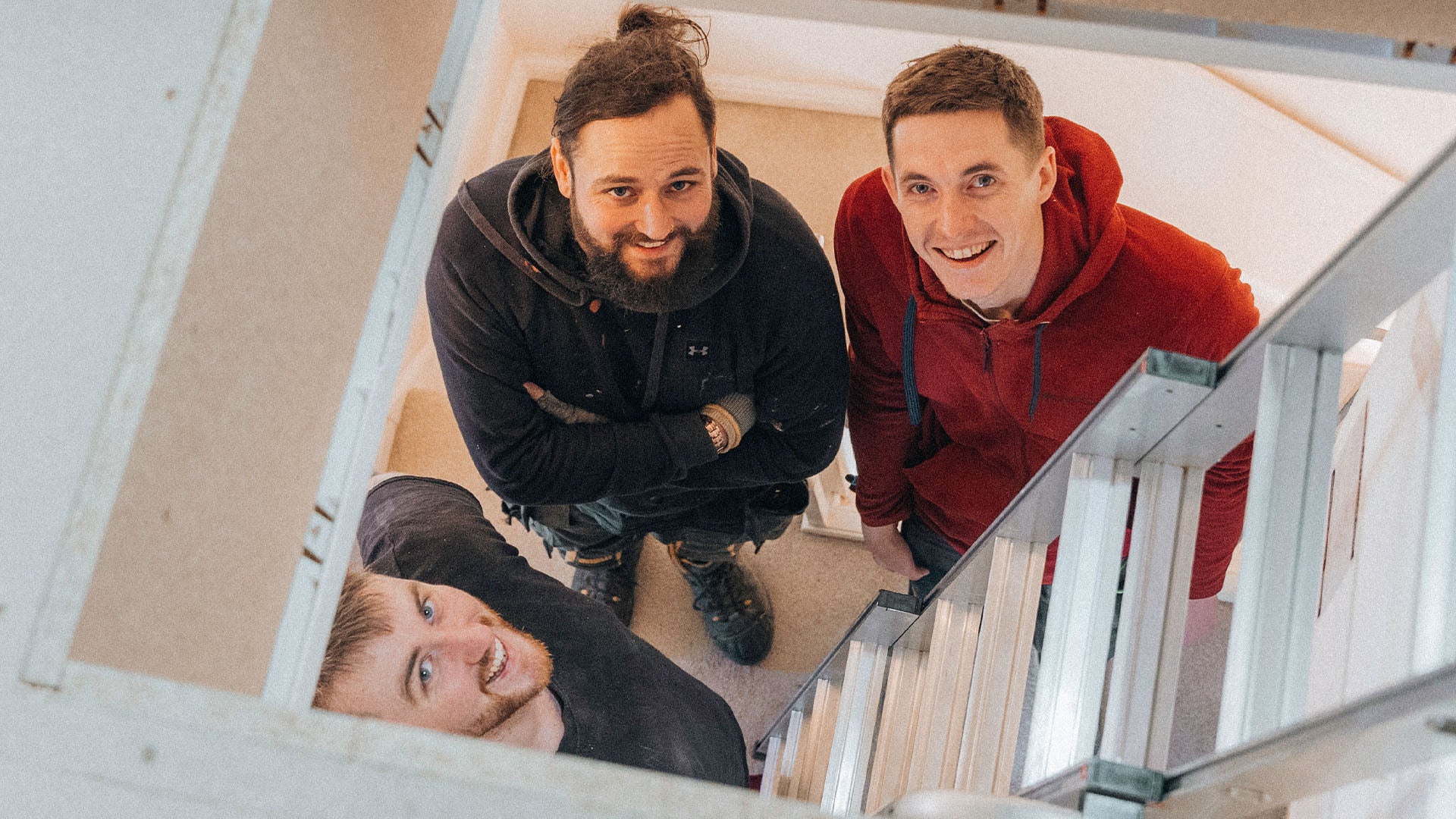 Loft installers looking up through the hatch — Loft-Trac