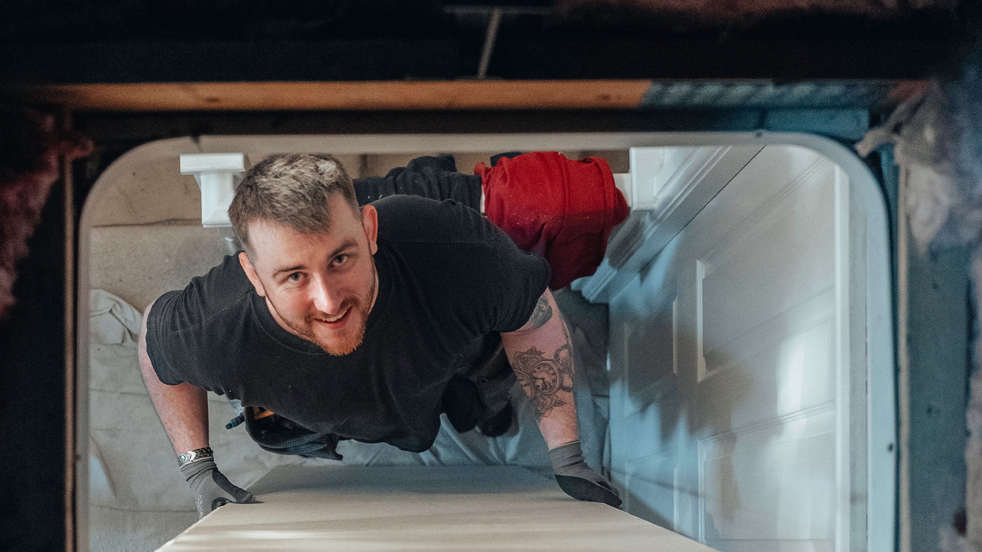 Loft installer looking up through loft hatch — Loft-Trac